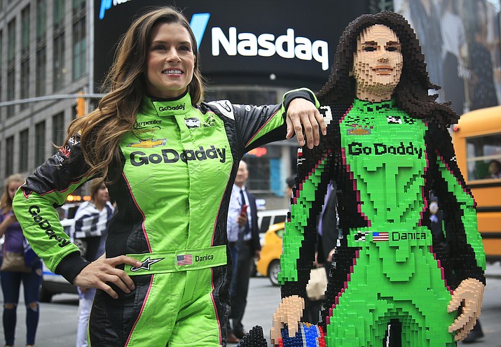 Race driver Danica Patrick, left, pose with a life-size Lego statue creation of herself, Tuesday, May 22, 2018, in New York. Lego master builder Chris Steininger says it took him 200 hours to build, using under 15,000 pieces and 13 different colors. (Bebeto Matthews/AP)