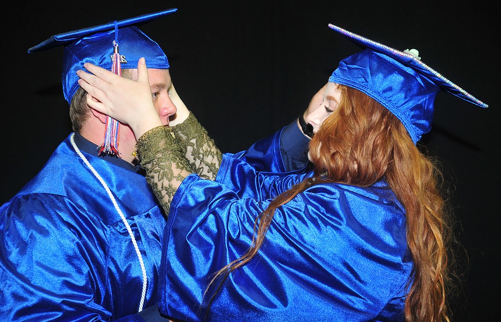 Devon Kirk and Autumn Turner make final adjustments before the Chino Valley Commencement held Wednesday, May 23, 2018 at the Prescott Valley Event Center. (Les Stukenberg/Courier)