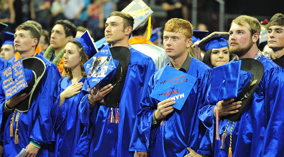 Removing their mortar boards for the National Anthem at the Chino Valley Commencement held Wednesday, May 23, 2018 at the Prescott Valley Event Center. (Les Stukenberg/Courier)