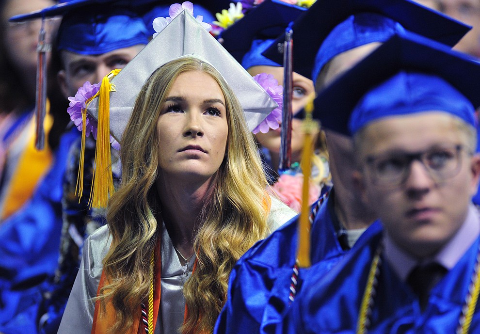 Watching the senior memories video on the big screens at the Chino Valley Commencement held Wednesday, May 23, 2018 at the Prescott Valley Event Center. (Les Stukenberg/Courier)