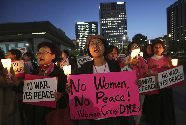 Women protesters shout slogans during a rally fopr peace on the Korea peninsular near U.S. Embassy in Seoul, Wednesday, May 23, 2018. U.S. President Donald Trump labored with South Korea's Moon Jae-in Tuesday to keep the highly anticipated U.S. summit with North Korea on track after Trump abruptly cast doubt that the June 12 meeting would come off. Setting the stakes sky high, Moon said, "The fate and the future of the Korean Peninsula hinge" on the meeting. (AP Photo/Ahn Young-joon)

