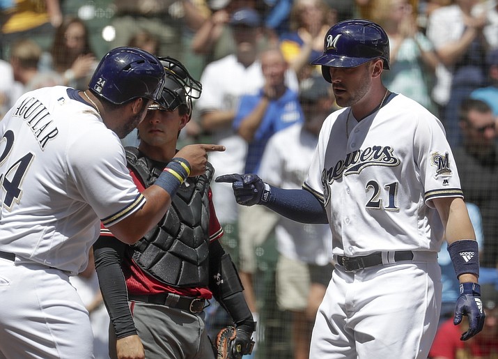 Milwaukee Brewers' Jesus Aguilar congratulates Travis Shaw (21) after his three-run home run during the fourth inning of a baseball game against the Arizona Diamondbacks Wednesday, May 23, 2018, in Milwaukee. (Morry Gash/AP)