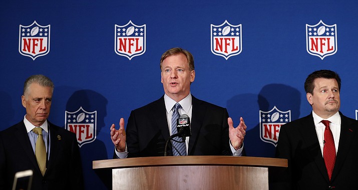 NFL commissioner Roger Goodell, center, is flanked by Pittsburgh Steelers president Art Rooney II, left, and Arizona Cardinals owner Michael Bidwill during a news conference where he announced that NFL team owners have reached agreement on a new league policy that requires players to stand for the national anthem or remain in the locker room, during the NFL owner's spring meeting Wednesday, May 23, 2018, in Atlanta. (John Bazemore/AP)
