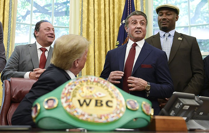 President Donald Trump, second from left, listens as Sylvester Stallone speaks during an event in the Oval Office of the White House in Washington, Thursday, May 24, 2018, where Trump posthumously pardoned Jack Johnson, boxing’s first black heavyweight champion. Trump is joined Keith Frankel, left, and former heavyweight champion Lennox Lewis. (Susan Walsh/AP)
