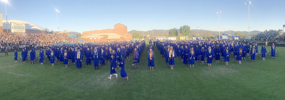 The 349 members of Prescott High School’s Class of 2018 gather at the beginning of their commencement ceremony Friday, May 25, 2018, as the color guard comes forward, on Bill Shepherd Field at Prescott High School. (Les Stukenberg/Courier)