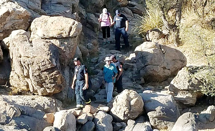 Prescott firefighters hike out with a 72-year-old man, who had reportedly lost consciousness on the north side of Watson Lake. The man was dehydrated. (Prescott Fire/Courtesy)