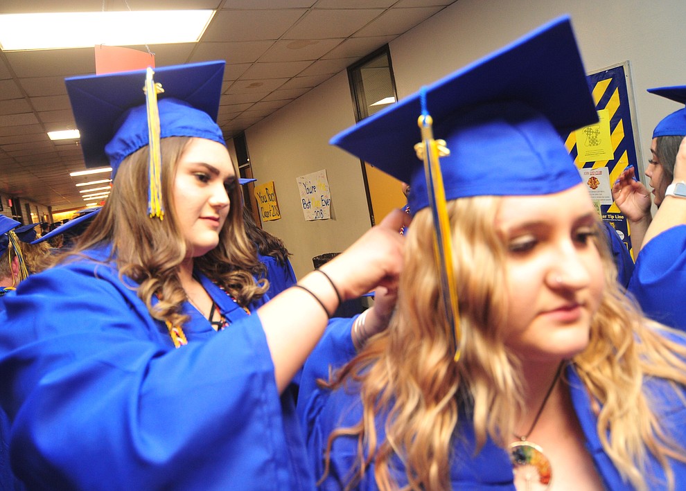 Brittany Resendez helps Madison Thompson with her hair before the 2018 Prescott High School Commencement Ceremony at the school Friday, May 25, 2018. (Les Stukenberg/Courier)
