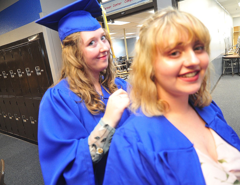 Giselle Lewis helps Abbey Stockmar with her hair before the 2018 Prescott High School Commencement Ceremony at the school Friday, May 25, 2018. (Les Stukenberg/Courier)