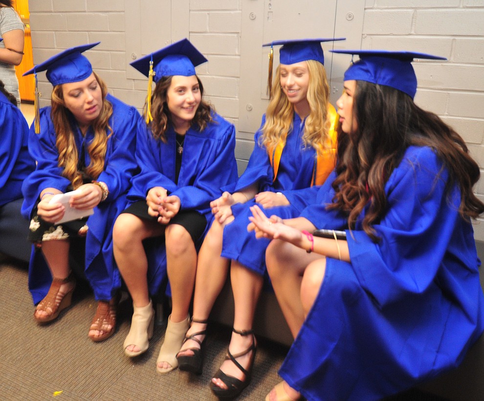 Abby Nelson, Hannah Nelson, Scarlett Manrique and Renee Kasten talk before the 2018 Prescott High School Commencement Ceremony at the school Friday, May 25, 2018. (Les Stukenberg/Courier)