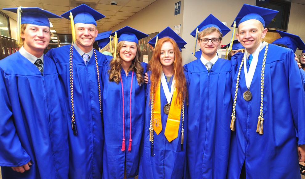 Ryan Holloway, Chase Kasun, Maggie Boelts, Audrey Lockling, Logan Hoots and Isaak Garasha pose for a photo before the 2018 Prescott High School Commencement Ceremony at the school Friday, May 25, 2018. (Les Stukenberg/Courier)