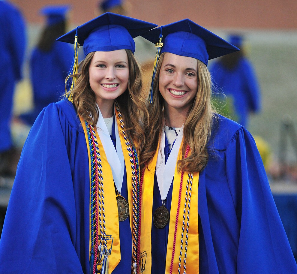 Lexi Hammes and McKenzie Roberts pose during the 2018 Prescott High School Commencement Ceremony at the school Friday, May 25, 2018. (Les Stukenberg/Courier)