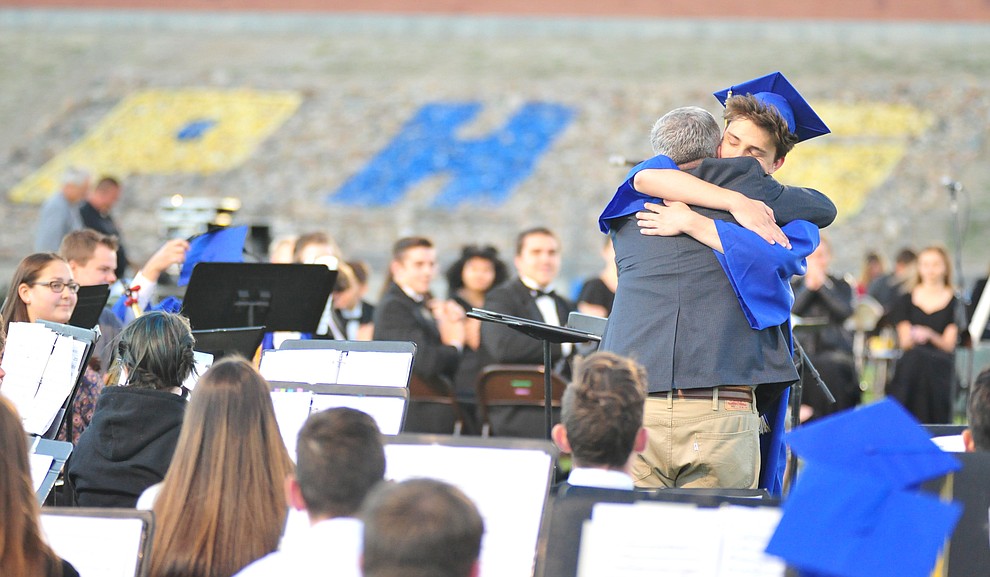 Dan Bradstreet gets a hug from his son Wesley during the 2018 Prescott High School Commencement Ceremony at the school Friday, May 25, 2018. (Les Stukenberg/Courier)