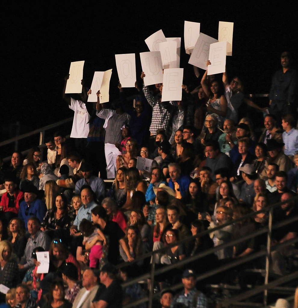 Fans cheer and raise signs during the 2018 Prescott High School Commencement Ceremony at the school Friday, May 25, 2018. (Les Stukenberg/Courier)