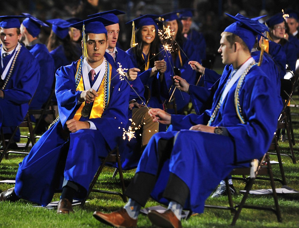 Graduates light sparklers during the 2018 Prescott High School Commencement Ceremony at the school Friday, May 25, 2018. (Les Stukenberg/Courier)