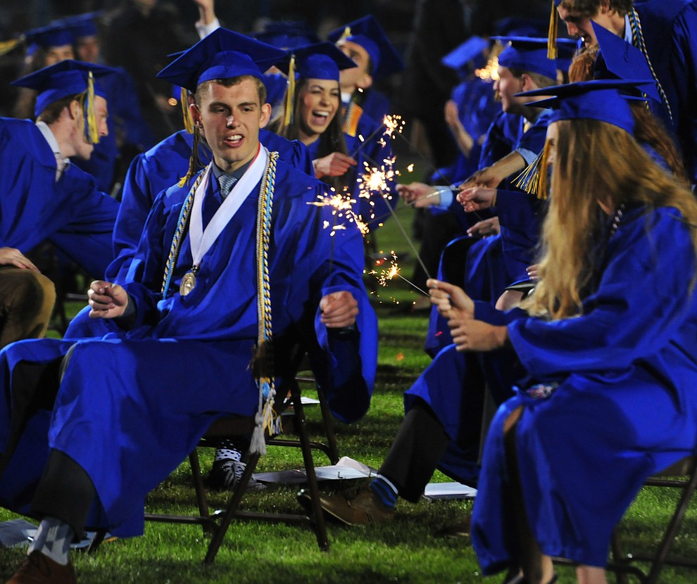 Graduates light sparklers during the 2018 Prescott High School Commencement Ceremony at the school Friday, May 25, 2018. (Les Stukenberg/Courier)