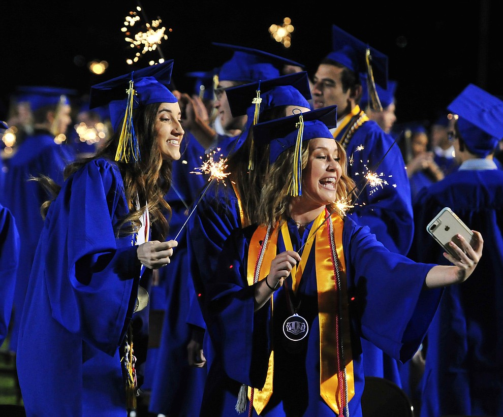 Graduates light sparklers during the 2018 Prescott High School Commencement Ceremony at the school Friday, May 25, 2018. (Les Stukenberg/Courier)