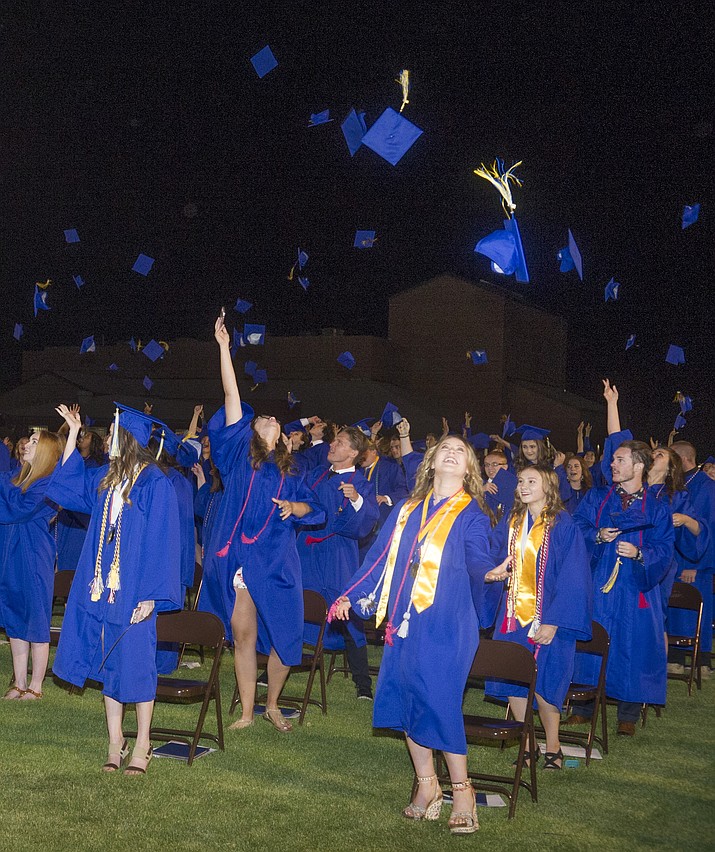 Graduates toss their mortar boars skyward during the 2018 Prescott High School Commencement Ceremony at the school Friday, May 25, 2018. (Les Stukenberg/Courier)
