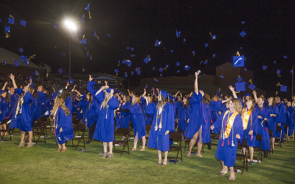 Graduates toss their mortar boars skyward during the 2018 Prescott High School Commencement Ceremony at the school Friday, May 25, 2018. (Les Stukenberg/Courier)
