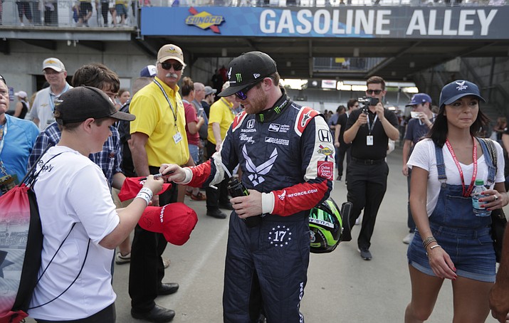 Conor Daly signs an autograph for a fan after he qualified for the IndyCar Indianapolis 500 auto race at Indianapolis Motor Speedway in Indianapolis, Saturday, May 19, 2018. (Michael Conroy/AP)

