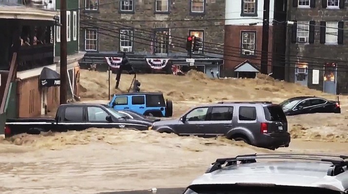 Water rushes through Main Street in Ellicott City, Md., Sunday, May 27, 2018. After the floodwaters receded, emergency officials had no immediate reports of fatalities or injuries. But by nightfall first responders and rescue officials were still going through the muddied, damaged downtown, conducting safety checks and ensuring people evacuated. (Libby Solomon/The Baltimore Sun via AP)

