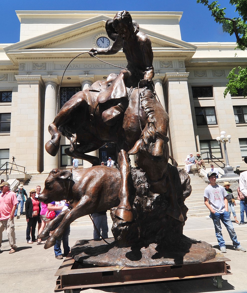 Viewers got an up close look at the statue called Cowboy in a Storm at the 44th Annual Phippen Museum Western Art Show on the courthouse plaza Saturday, May 26, 2018 in downtown Prescott. The statue eventually will be placed in the middle of the roundabout on Highway 89 in front of the Phippen Museum. (Les Stukenberg/Courier)