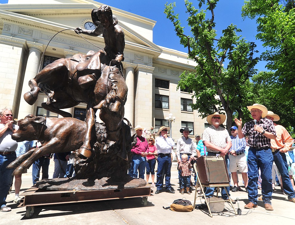 Darrell Phippen talks about his gratitude for the commissioning and work on the statue called Cowboy in a Storm at the 44th Annual Phippen Museum Western Art Show on the courthouse plaza Saturday, May 26, 2018 in downtown Prescott. The statue eventually will be placed in the middle of the roundabout on Highway 89 in front of the Phippen Museum. (Les Stukenberg/Courier)