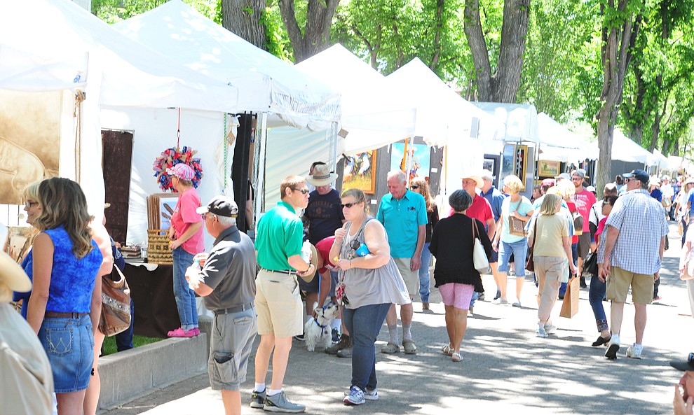 Patrons cruise through the booths at the 44th Annual Phippen Museum Western Art Show on the courthouse plaza Saturday, May 26, 2018 in downtown Prescott. (Les Stukenberg/Courier)
