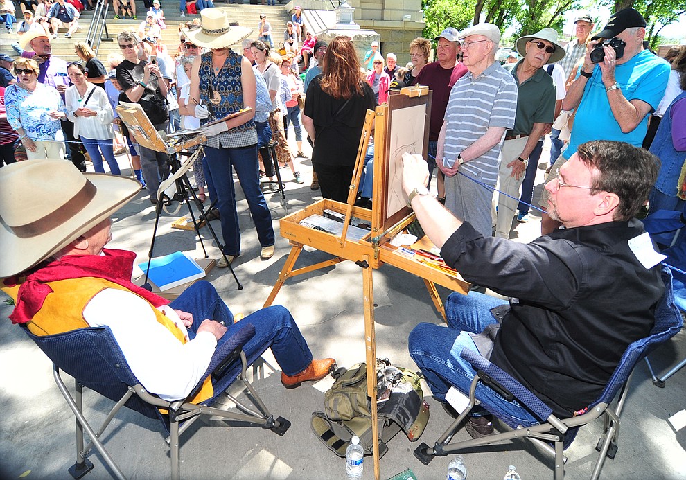 Steve Atkinson uses charcoal during the quick draw contest at the 44th Annual Phippen Museum Western Art Show on the courthouse plaza Saturday, May 26, 2018 in downtown Prescott. (Les Stukenberg/Courier)