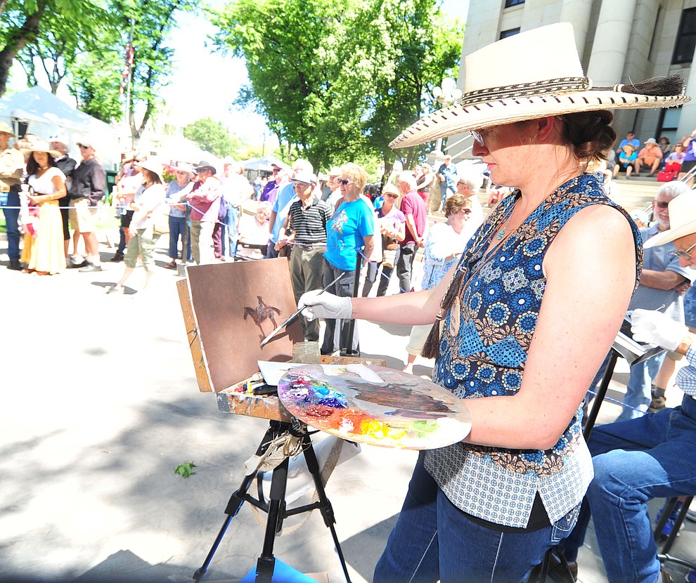 Sarah Phippen uses oils during the quick draw contest at the 44th Annual Phippen Museum Western Art Show on the courthouse plaza Saturday, May 26, 2018 in downtown Prescott. (Les Stukenberg/Courier)
