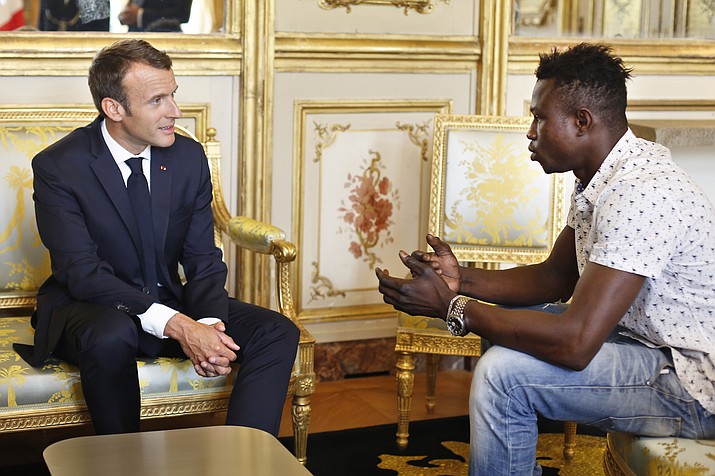 French President Emmanuel Macron, left, meets with Mamoudou Gassama, 22, from Mali, at the presidential Elysee Palace in Paris, Monday, May, 28, 2018. Mamoudou Gassama living illegally in France is being honored by Macron for scaling an apartment building over the weekend to save a 4-year-old child dangling from a fifth-floor balcony. (AP Photo/Thibault Camus, Pool)

