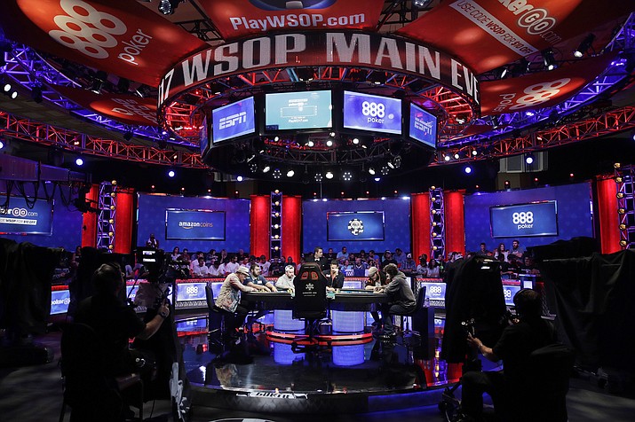 In this July 21, 2017 file photo players compete at the final table during the World Series of Poker in Las Vegas. The 2018 edition of the World Series of Poker is kicking off in Las Vegas. The 50-day series opened Tuesday, May 29, 2018 and is expected to again draw tens of thousands of players from around the world to compete for millions of dollars in prize money and gold bracelets. (AP Photo/John Locher,File)

