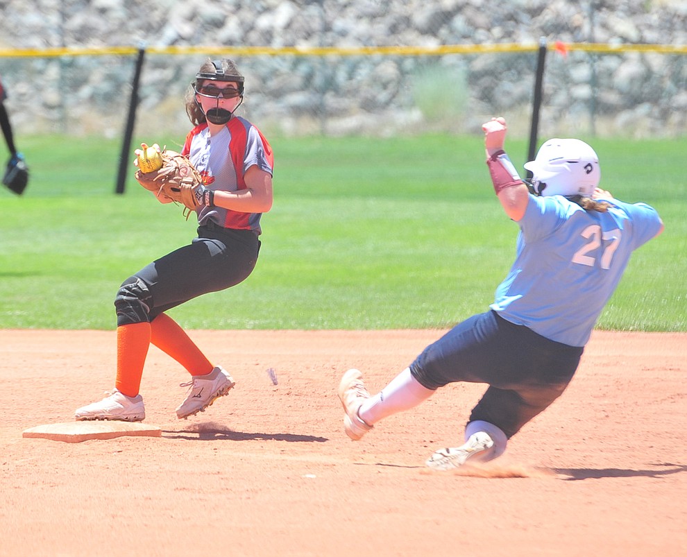 Prescott's Northern Fire's Leigha Walker tries to turn a double play at the Schools Out for Summer NSA fastpitch girls softball tournament at Pioneer Park in Prescott Saturday, June 2, 2018. (Les Stukenberg/Courier)