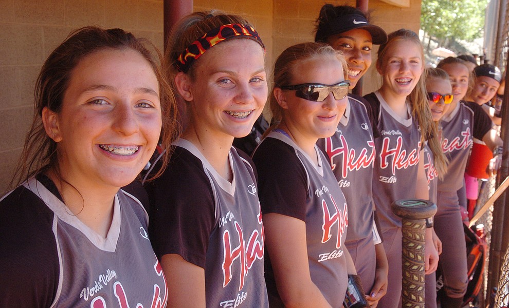Verde Valley Heat Elite 14U's gather on the bench before a game at the Schools Out for Summer NSA fastpitch girls softball tournament at Pioneer Park in Prescott Saturday, June 2, 2018. (Les Stukenberg/Courier)