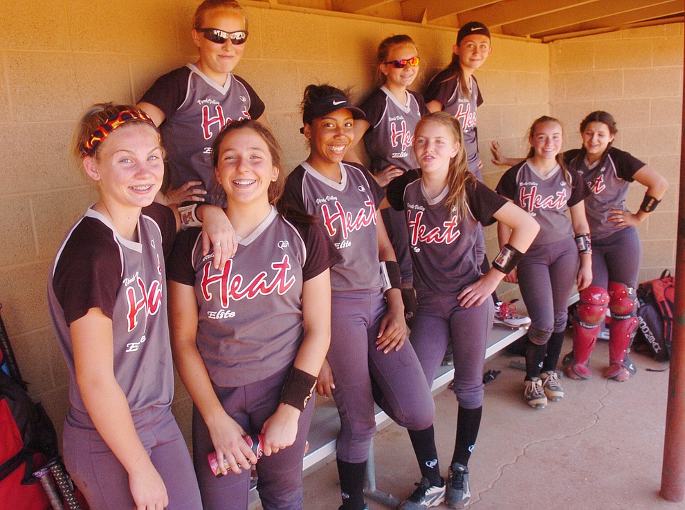 Verde Valley Heat Elite 14U's gather on the bench before a game at the Schools Out for Summer NSA fastpitch girls softball tournament at Pioneer Park in Prescott Saturday, June 2, 2018. (Les Stukenberg/Courier)