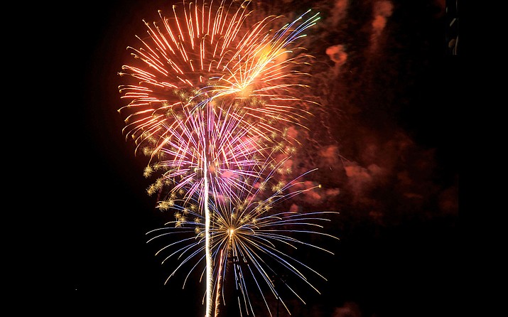 Bright colors rain down from the sky while the Fourth of July fireworks light up the Prescott sky. (Courier file photo)