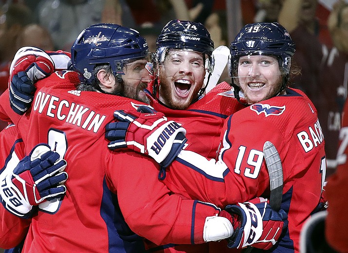 Washington Capitals defenseman John Carlson, center, celebrates his goal against the Vegas Golden Knights with Alex Ovechkin, left, of Russia, and Nicklas Backstrom, right, of Sweden, during the second period in Game 4 of the NHL hockey Stanley Cup Final, Monday, June 4, 2018, in Washington. (AP Photo/Alex Brandon)