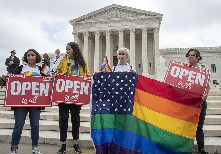 American Civil Liberties Union activists demonstrate in front of the Supreme Court, Monday, June 4, 2018 in Washington. The Supreme Court has ruled for a Colorado baker who wouldn't make a wedding cake for a same-sex couple in a limited decision that leaves for another day the larger issue of whether a business can invoke religious objections to refuse service to gay and lesbian people. (AP Photo/J. Scott Applewhite)

