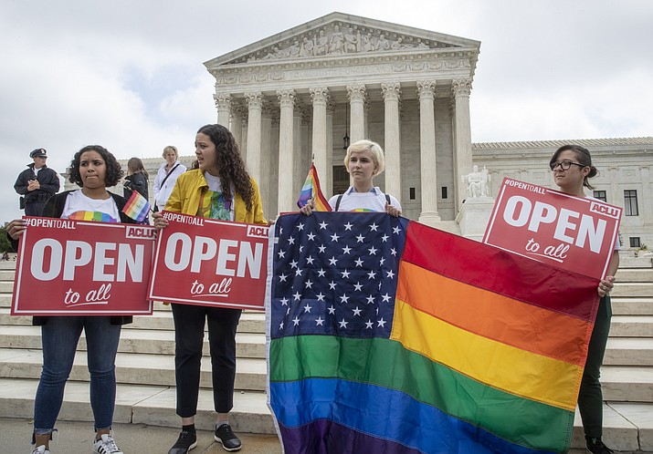 American Civil Liberties Union activists demonstrate in front of the Supreme Court, Monday, June 4, 2018 in Washington. The Supreme Court has ruled for a Colorado baker who wouldn't make a wedding cake for a same-sex couple in a limited decision that leaves for another day the larger issue of whether a business can invoke religious objections to refuse service to gay and lesbian people. (AP Photo/J. Scott Applewhite)

