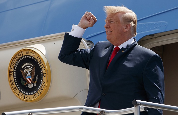 In this May 31, 2018 photo, President Donald Trump pumps his fist as he steps off Air Force One after arriving at Ellington Field Joint Reserve Base, in Houston. Trump is right that he has an “absolute” right to pardon, but there is a pretty big loophole in this hypothetical: He could still be impeached. (AP Photo/Evan Vucci)

