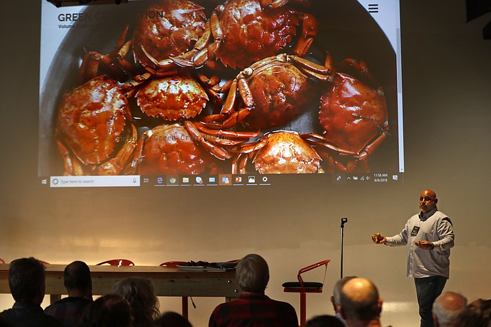 Jamie Bassett, a crabber from Chatham, Mass., gives presentation on culinary uses for the green crabs, at a conference, Wednesday, June 6, 2018, in Portland, Maine. Food scientists have gathered to find a way to monetize invasive green crabs, which are a major pest in shellfish harvesting communities. (AP Photos/Robert F. Bukaty)

