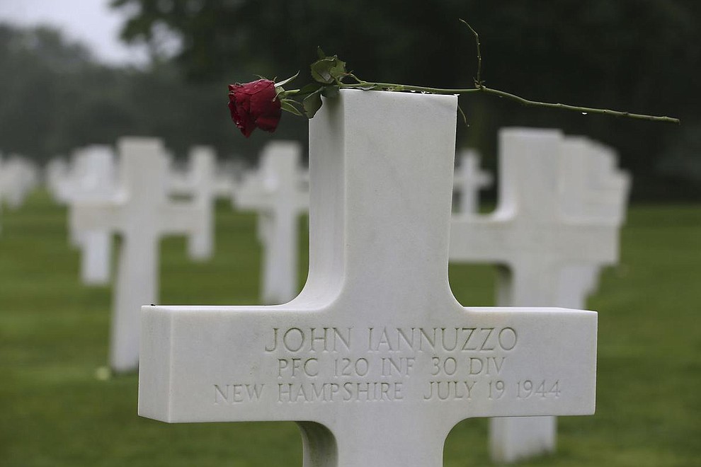 A red rose is placed on the headstone of John Iannuzzo, from New Hampshire 120th Infantry 30th division, at the Colleville American military cemetery, in Colleville sur Mer, western France, Wednesday June 6, 2018, on the 74th anniversary of the D-Day landing. U.S. and other allied troops have joined veterans of the D-Day invasion and families of fallen soldiers to mark 74 years since the massive military operation that change the course of World War II. (AP Photo/David Vincent)