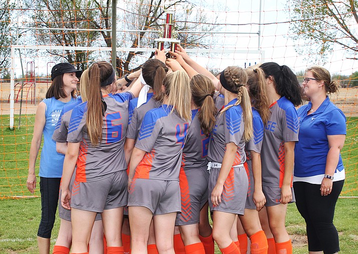 The Heritage Middle School girls soccer team hoists the championship trophy after a 4-1 win over Humboldt on April 27 in Chino Valley. The girls were 11-0 this season. (Heritage/Courtesy)