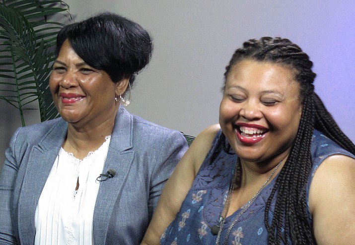 Alice Marie Johnson, left, and her daughter Katina Marie Scales wait to start a TV interview on Thursday, June 7, 2018 in Memphis, Tenn. Johnson, 63, whose life sentence was commuted by President Donald Trump thanked him on Thursday for "having mercy" and said reality TV star Kim Kardashian West saved her life. (AP Photo/Adrian Sainz).

