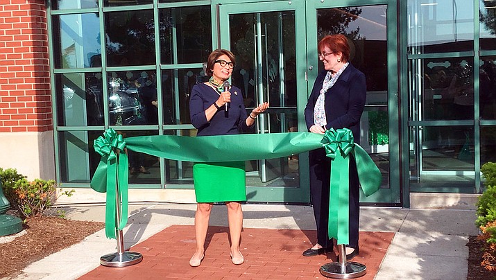 Sylvia Acevedo, left, CEO of the Girl Scouts of the USA, speaks at a ribbon-cutting ceremony for a new headquarters for the southeastern Michigan chapter, as Denise Dalrymple, CEO of the Girl Scouts of Southeastern Michigan, watches on Wednesday, June 6, 2018, in Detroit. Acevedo says that while her organization is disappointed that the Boy Scouts have decided to accept girls it is focused on helping “parents understand the benefits of Girl Scouts.” (AP Photo/Mike Householder)