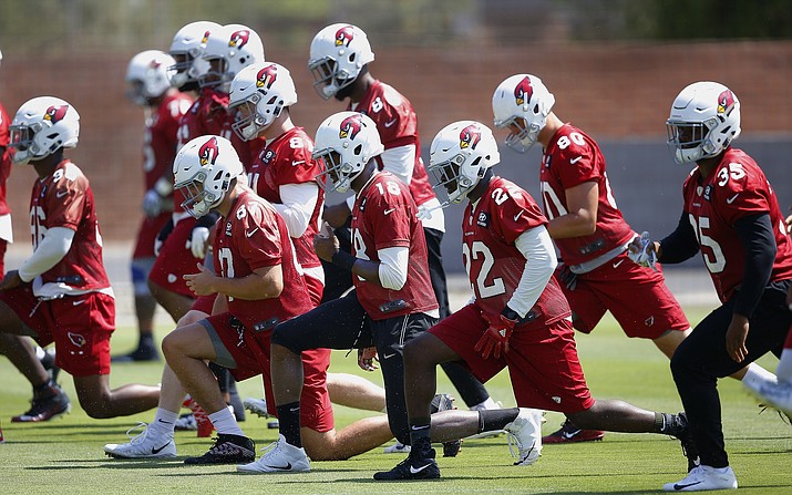 Arizona Cardinals’ Alec Bloom (87), Brice Butler (18), T.J. Logan (22), Bryce Williams (80), and Elijhaa Penny (35) stretch with teammates during the NFL football team’s minicamp Thursday, June 14, 2018, in Tempe. (Ross D. Franklin/AP)