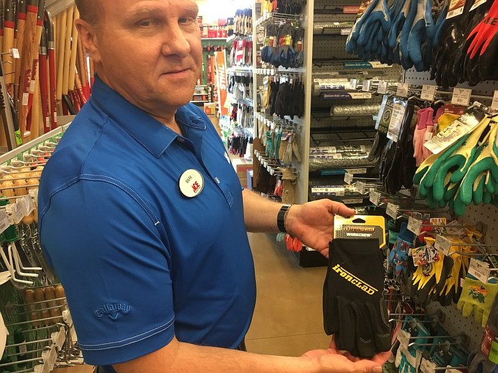 In this Thursday, June 14, 2018 photo, Mark Driscoll, owner of the Ace Hardware in Sugar Grove, Ill., holds a pair of gloves like the type he tried on recently and discovered a man’s ring in one of the fingers. He’s now trying to find the owner of the ring but so far has had no luck. (Denise Crosby/Chicago Tribune via AP)

