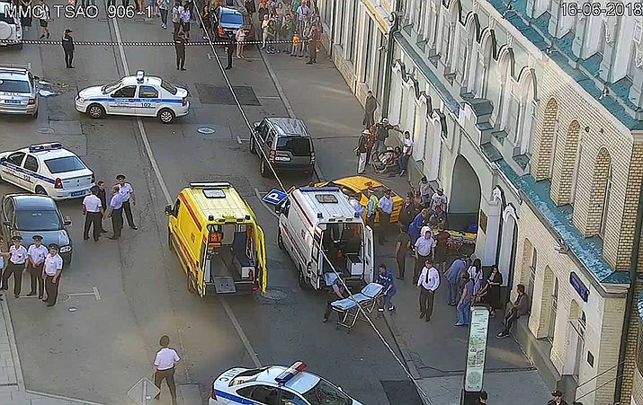 In this image provided by Moscow Traffic Control Center Press Service, ambulance and police work at the site of an incident after a taxi crashed into pedestrians on a sidewalk near Red Square in Moscow, Russia, Saturday, June 16, 2018. Police in Moscow say at least seven people have been injured when a taxi crashed into pedestrians on a sidewalk near Red Square. (Moscow Traffic Control Center Press Service via AP)

