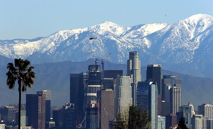 In this Jan. 12, 2016 file photo, the snow-capped San Gabriel Mountains stand as a backdrop to the downtown Los Angeles skyline. An initiative that seeks to split California into three states is projected to qualify for the state’s November 2018 ballot. The latest proposal for splitting up the Golden State would create the states of Northern California, Southern California and a narrow central coast strip retaining the name California. Even if voters approve the initiative an actual split would still require the approval of the state Legislature and Congress. (AP Photo/Nick Ut, File)

