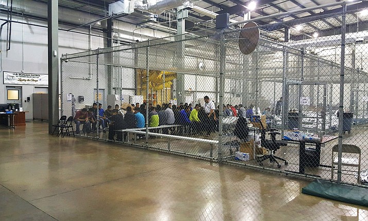 In this photo provided by U.S. Customs and Border Protection, people who've been taken into custody related to cases of illegal entry into the United States, sit in one of the cages at a facility in McAllen, Texas, Sunday, June 17, 2018. (U.S. Customs and Border Protection's Rio Grande Valley Sector via AP)


