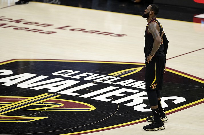 In this June 8, 2018, file photo, Cleveland Cavaliers’ LeBron James watches during the first half of Game 4 of basketball’s NBA Finals against the Golden State Warriors, in Cleveland. James has until June 29 to exercise his $35.6 million contract option for next season or decline it and become an unrestricted free agent, officially making him the planet’s best and most coveted player. The 33-year-old is not expected to reveal his intentions until after the draft. (Tony Dejak/AP, File)